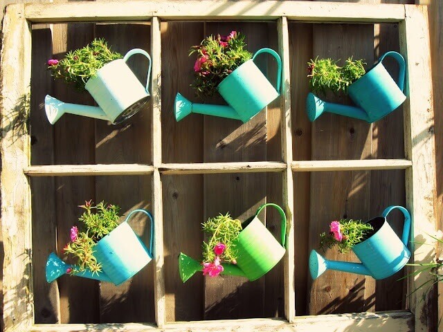 Whimsical Painted Watering Cans with Flowers