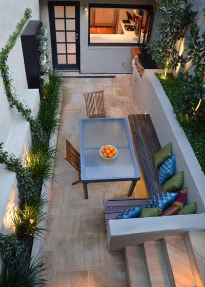 For this long, narrow patio, a long, narrow dining table and built-in benches are just the right fit.