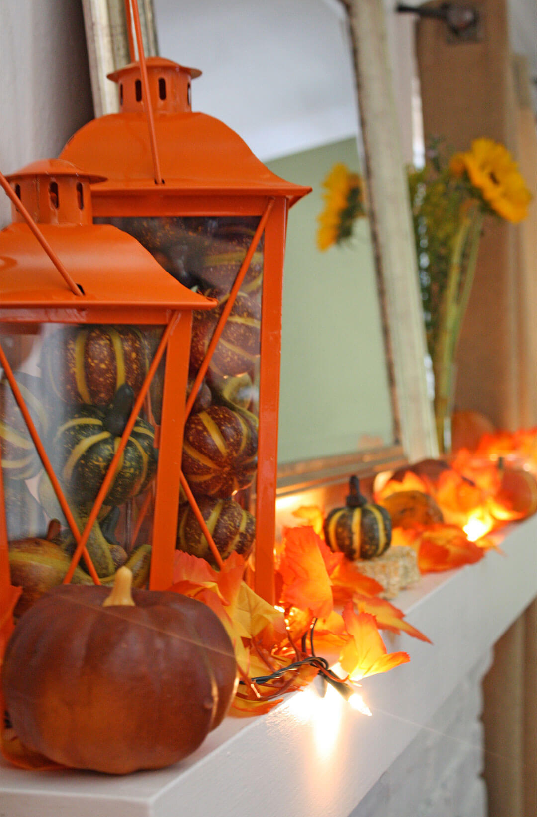 Orange Glow and Lanterns Light this Mantel | Fall Mantel Decorating Ideas For Halloween
