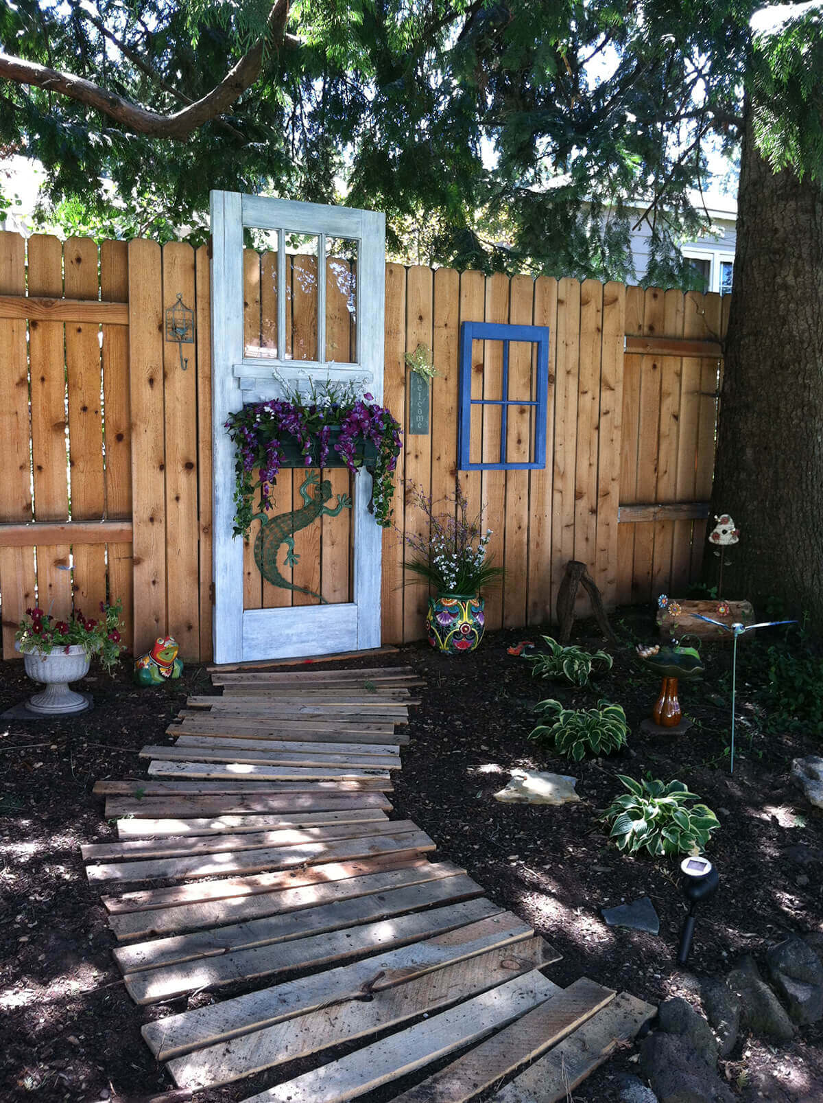 Old Door Hanging on the Fence | Creative Repurposed Old Door Ideas & Projects For Your Backyard