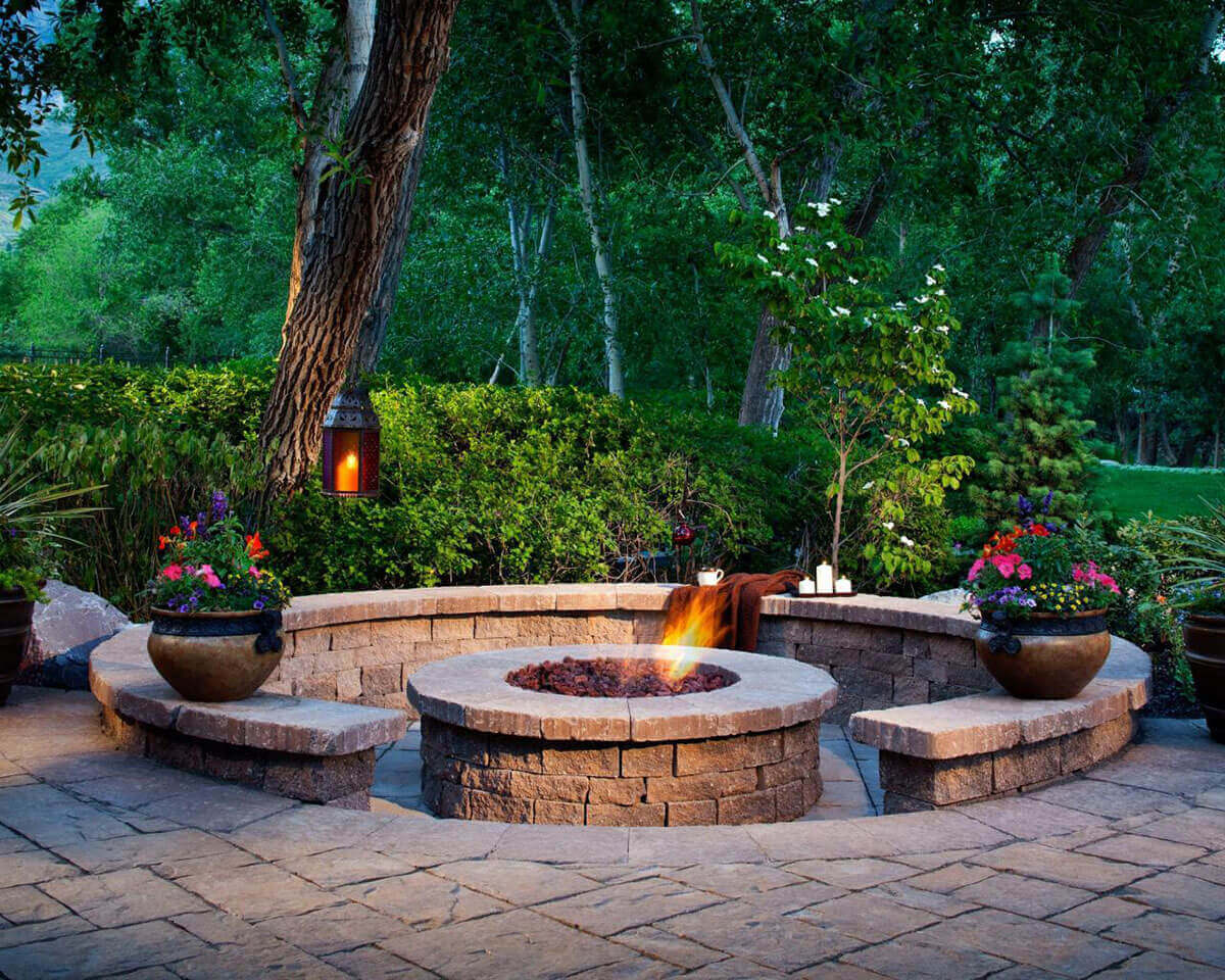 A Firepit Enhanced by Shrubs and Flowers | Awesome Firepit Area Ideas For Your Outdoor Activities
