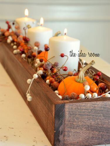Cushion candles, pumpkins, and berry garlands with Spanish moss | DIY Fall Candle Decoration Ideas - Farmfoodfamily.com