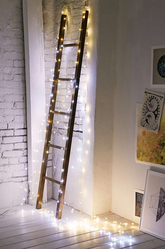 Make decorative ladder Christmas ready encasing lights