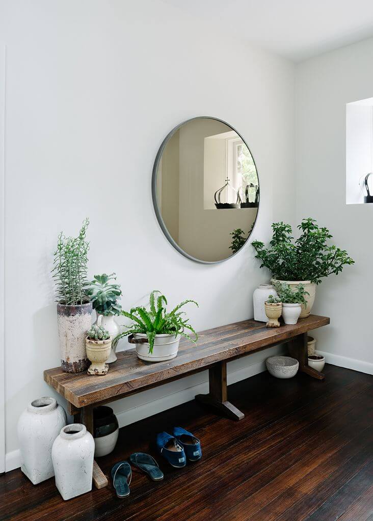 Round mirror above a bench with planters | Best Entryway Mirror Decor Ideas