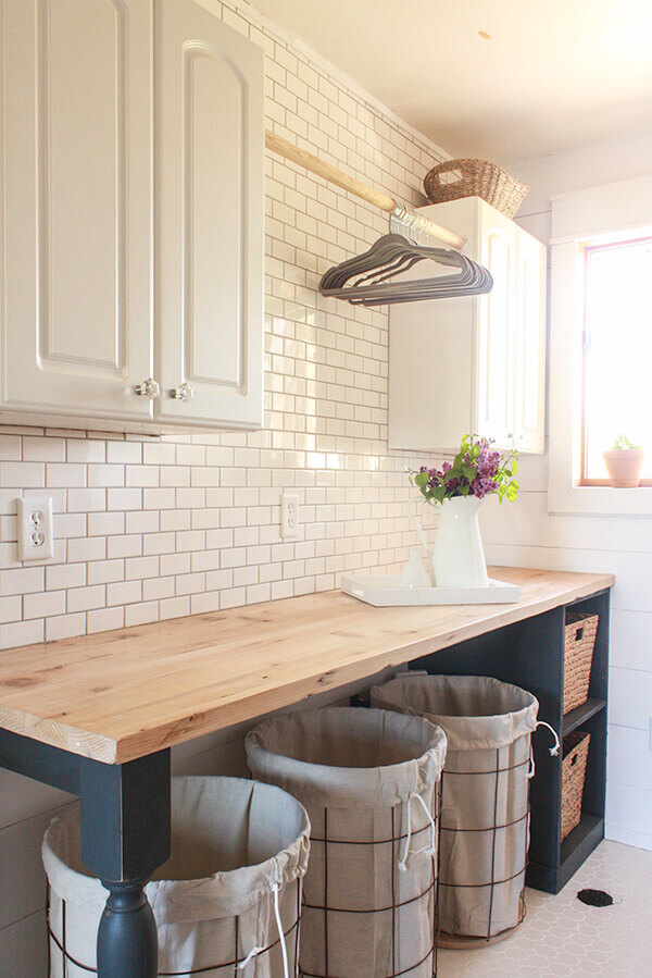 DIY Farmhouse Laundry Room Ideas: Turned table legs painted and wire laundry baskets from old tomato cages