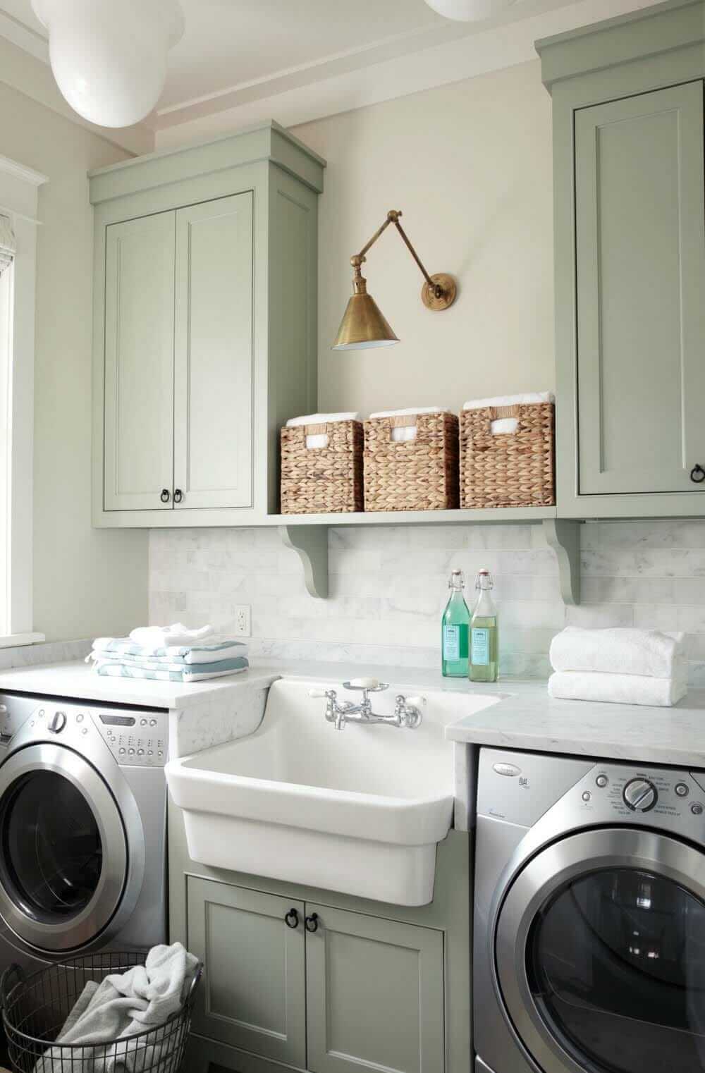 DIY Farmhouse Laundry Room Ideas: Self cabinet above white sink with marble slab countertop