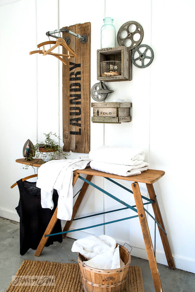 DIY Farmhouse Laundry Room Ideas: Reclaimed wood and pipe LAUNDRY sign hanging station