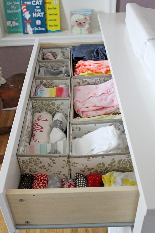 The organizer of baby clothes in the drawers