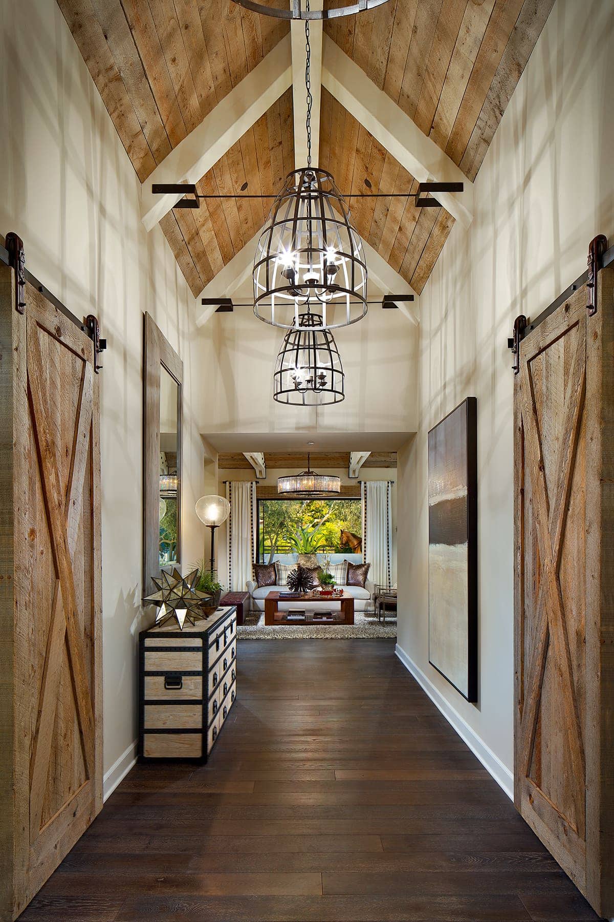 A large hallway with light fixtures, and wood sliding doors