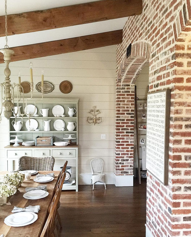 Reclaimed brick walls with barn beams and light fixtures