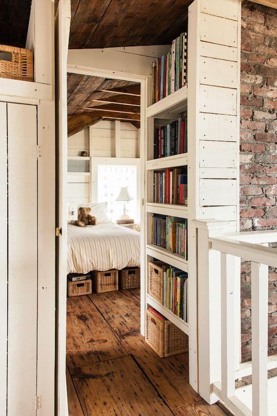 A large built-in bookcase with exposed brick walls