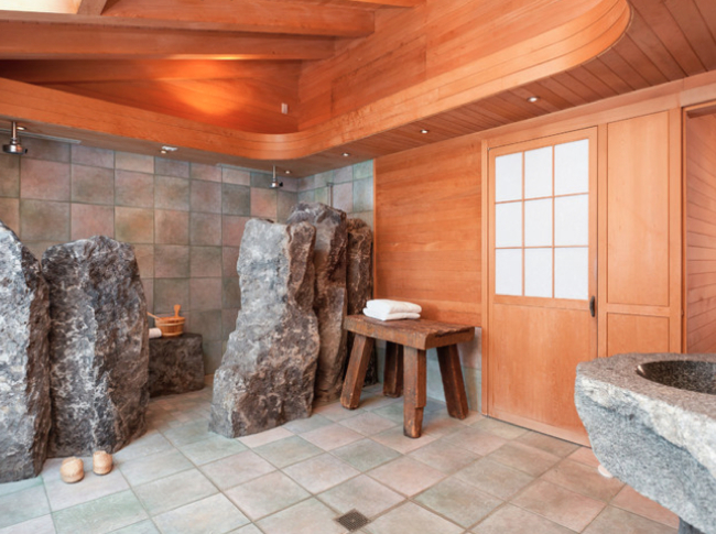 bathroom with stone designs and wooden walls
