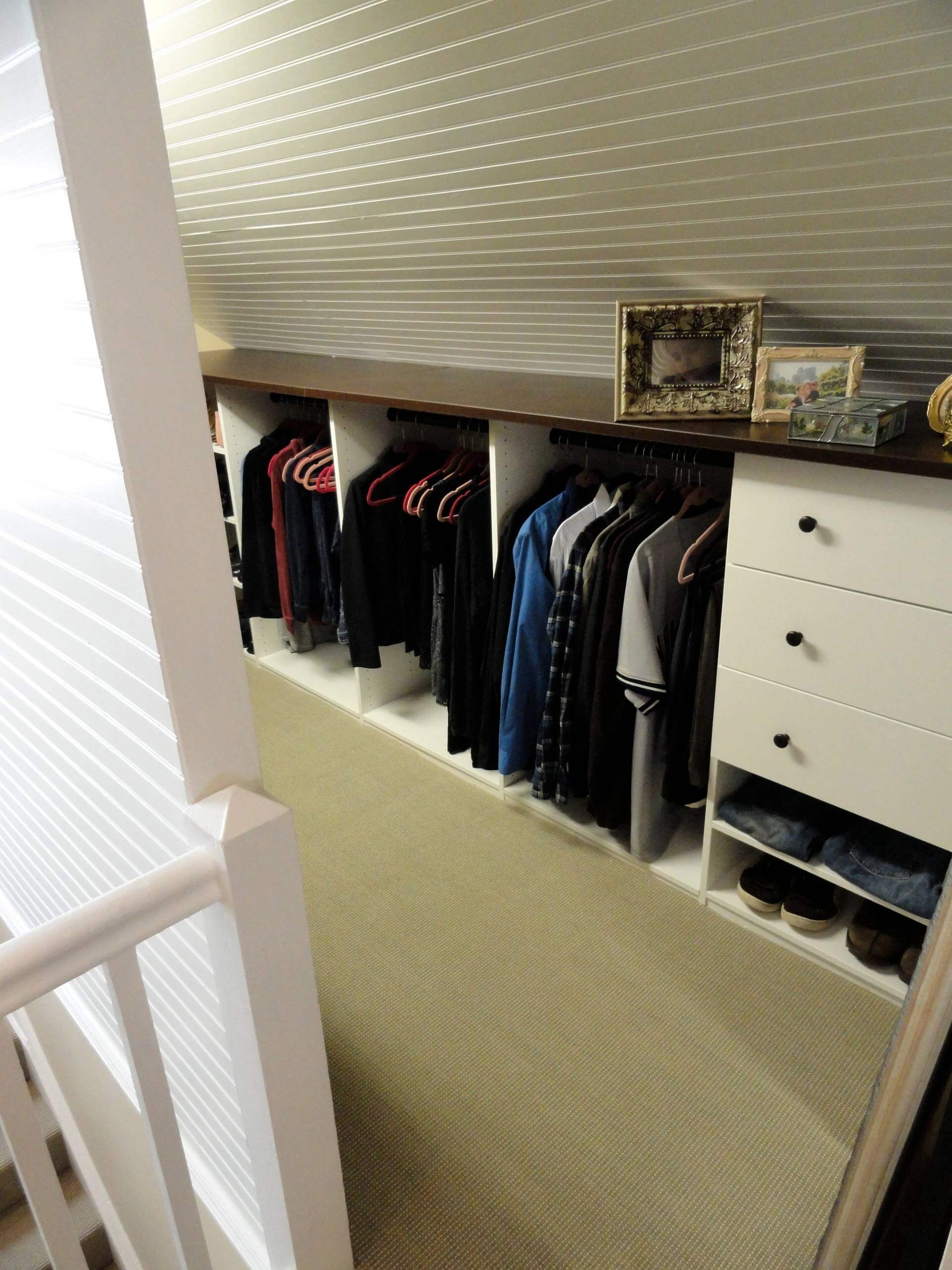 A closet with drawer on the lower end of the attic