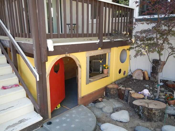 A Backyard with a Playhouse under the Deck