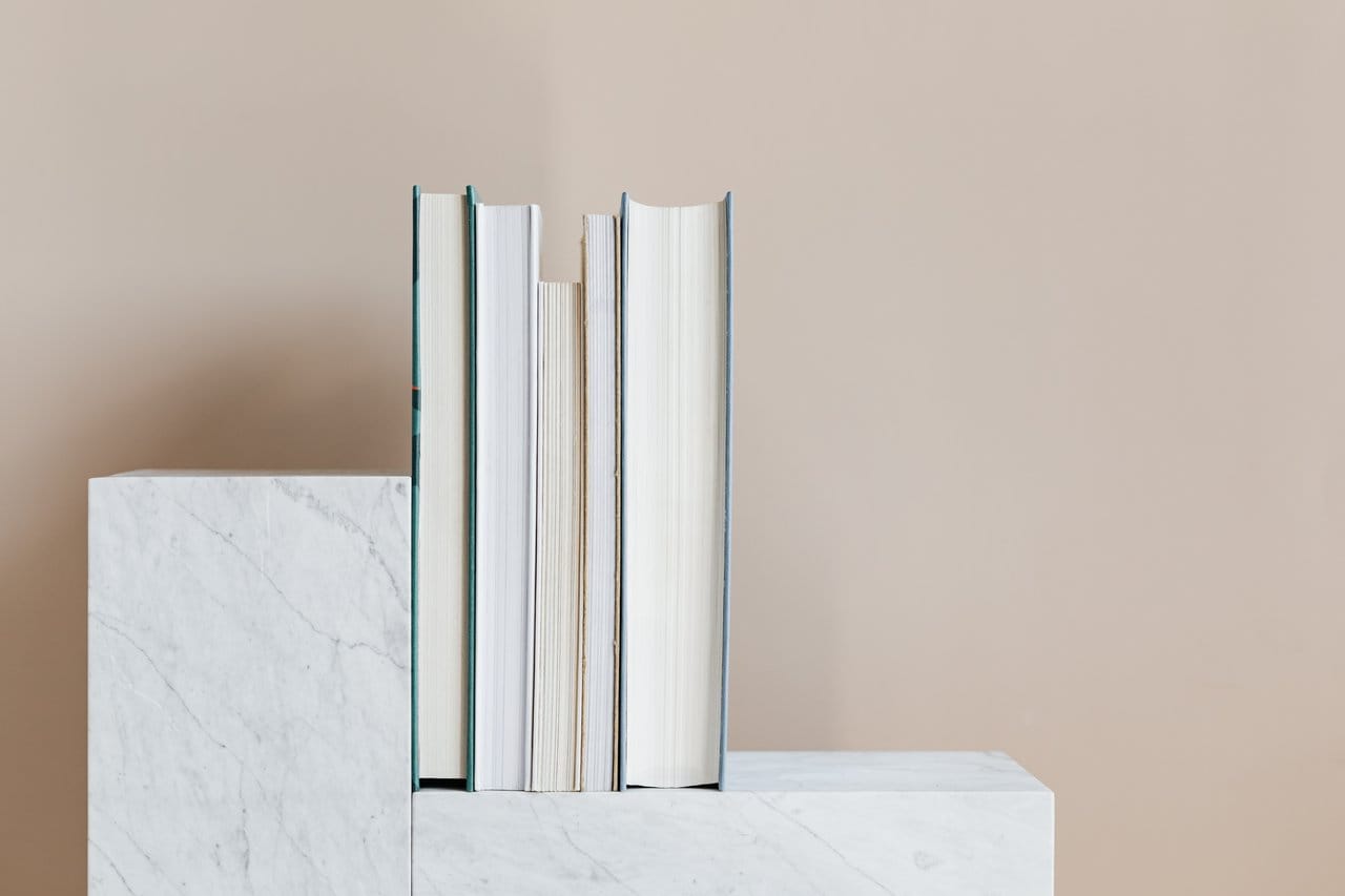 set of books placed on marble shelf