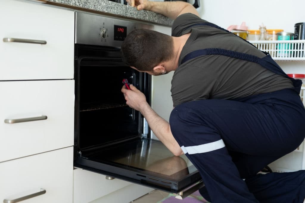 repairing oven in kitchen