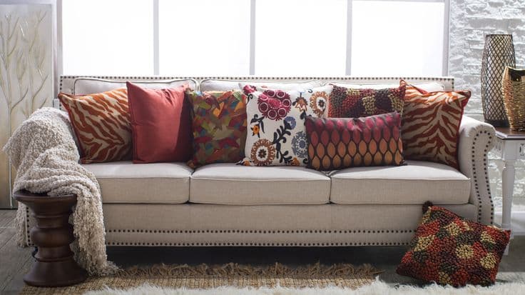 15 orange pillows with beige sofas