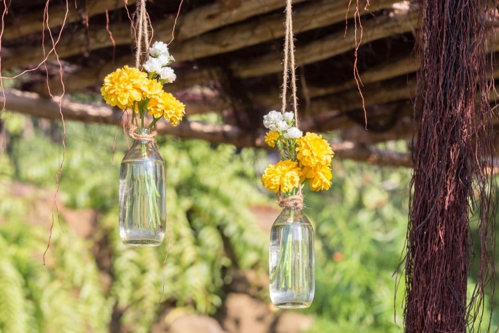 3 plastic flowers decorated in a bottle