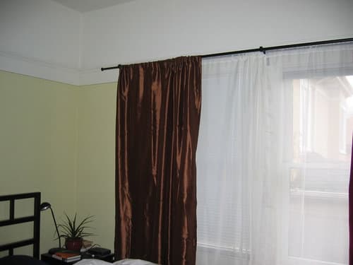 4 brown curtains with green walls