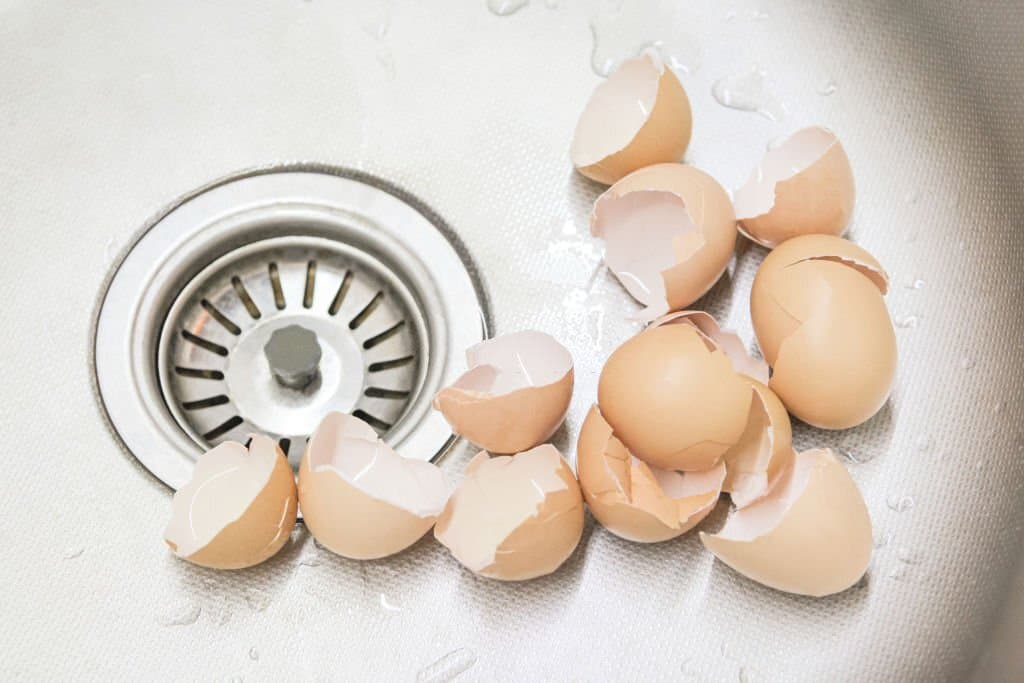 broken eggshell from a few eggs in the kitchen sink