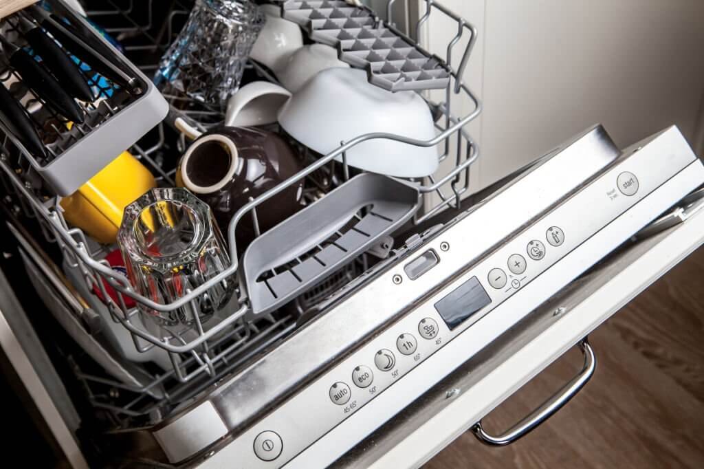 clean dishes in dishwasher machine after washing cycle