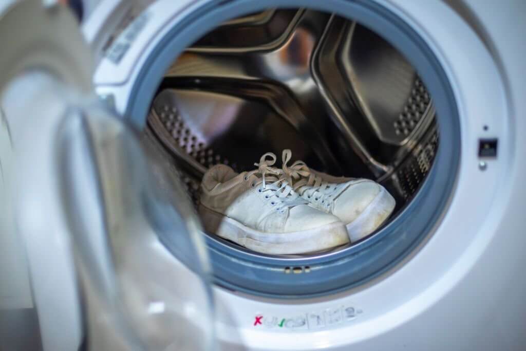 dirty white sneakers in the washing machine