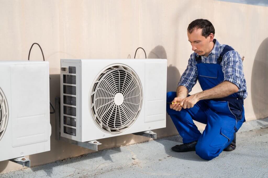 echnician repairing air conditioning system