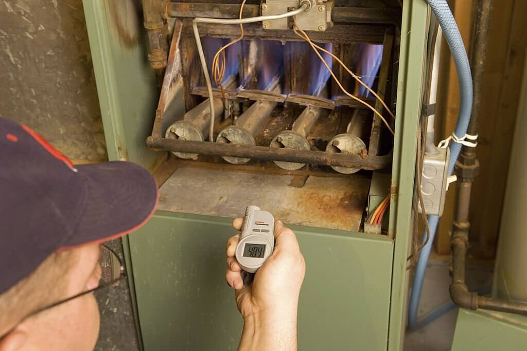 thermometer checks gas furnace output temperature