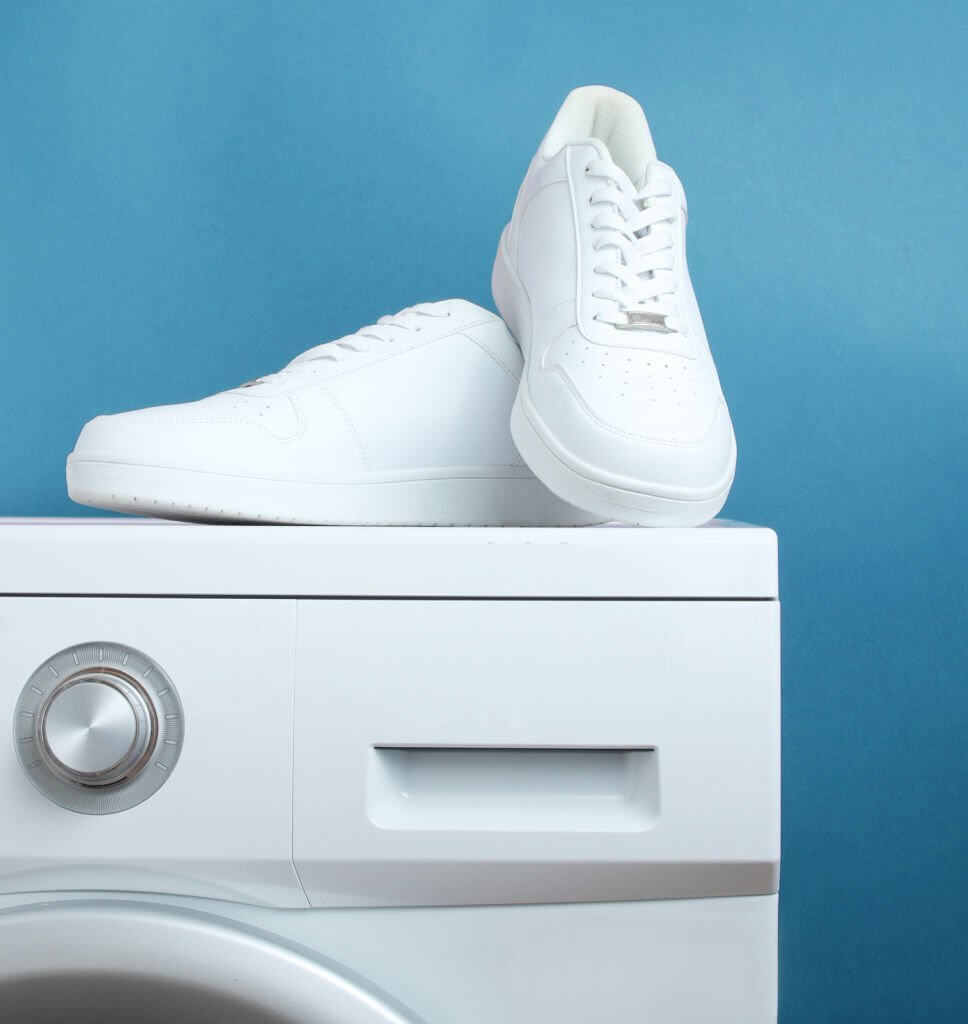 white fashion sneakers on the washing machine