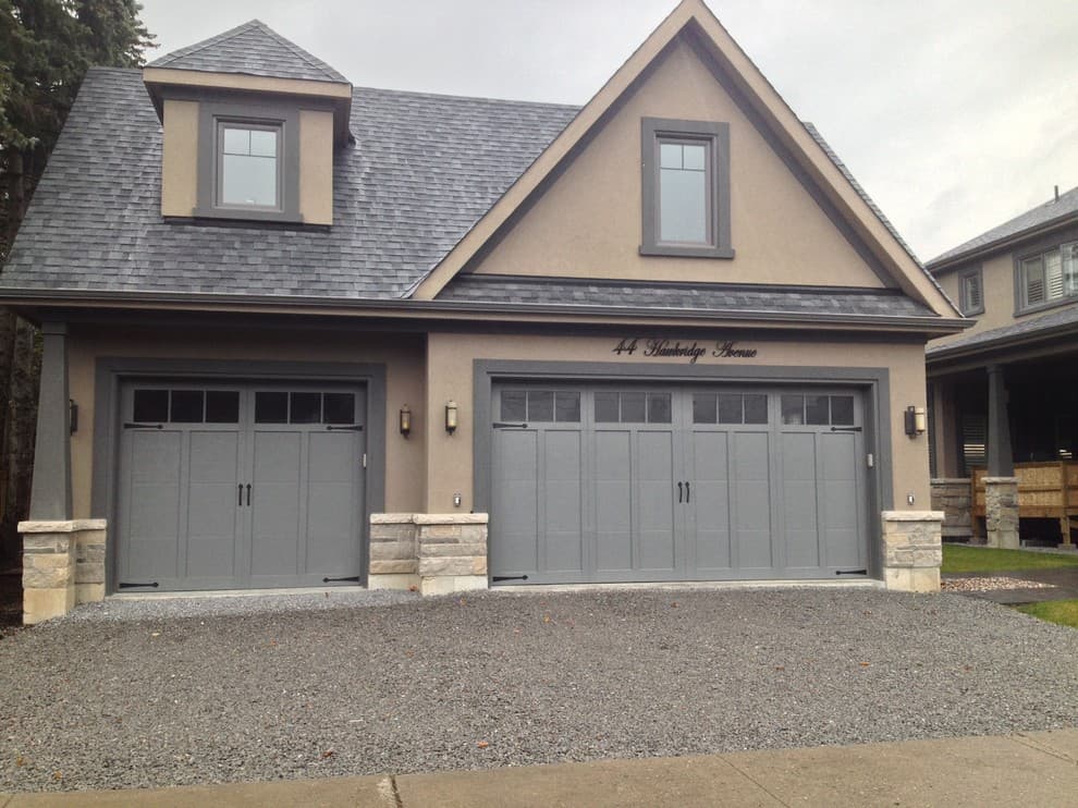 Charcoal garage door with beige house