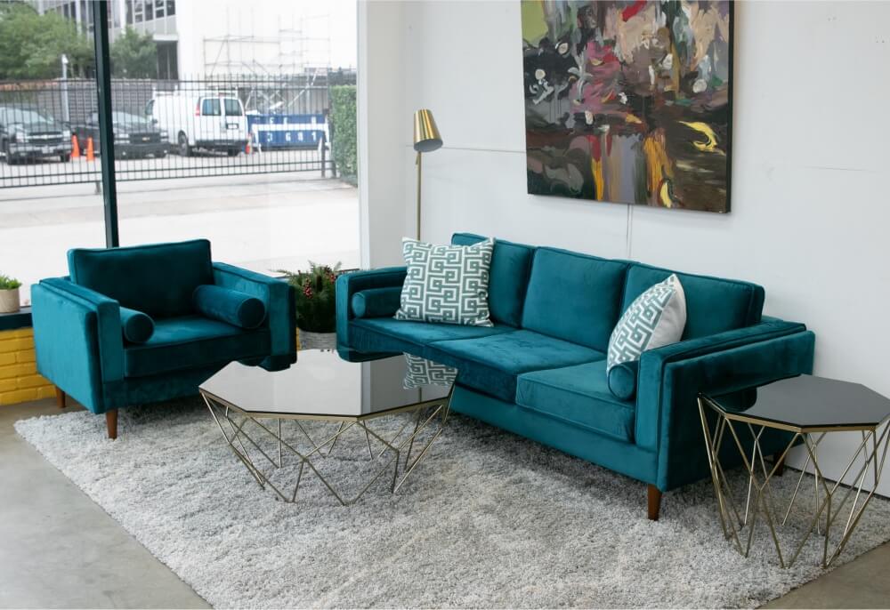 Emerald green couch with gray walls