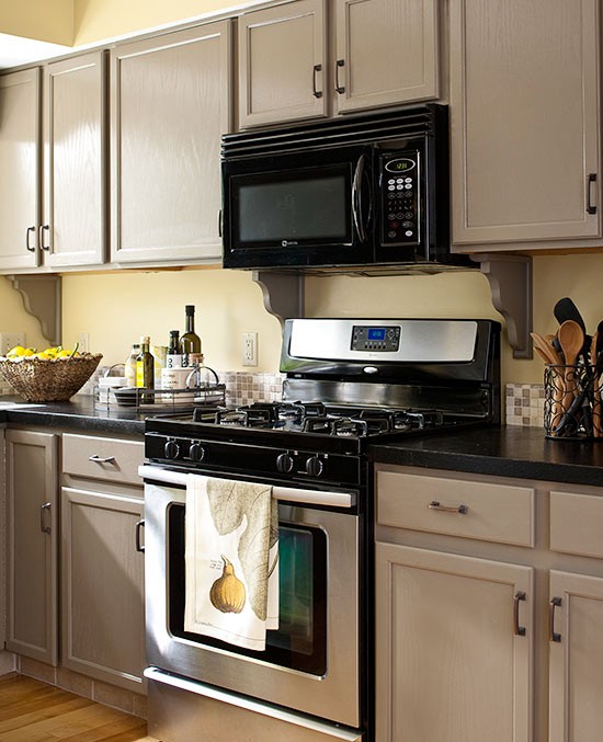 Greige cabinets with black stainless steel appliances