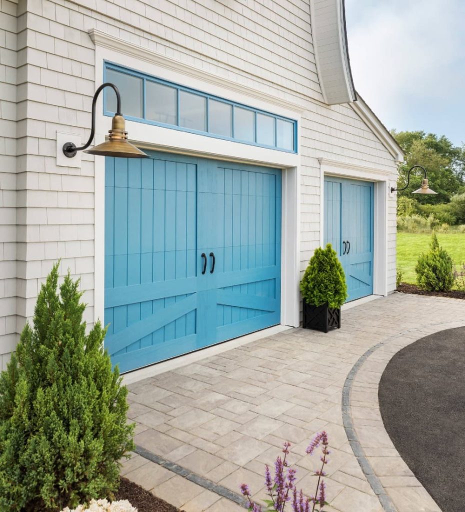 Turquoise garage door with beige house