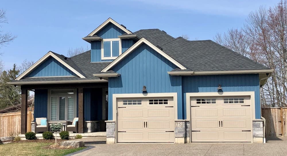 beige garage door with blue house