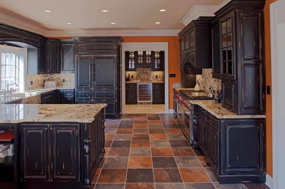 black cabinets with brown granite countertops