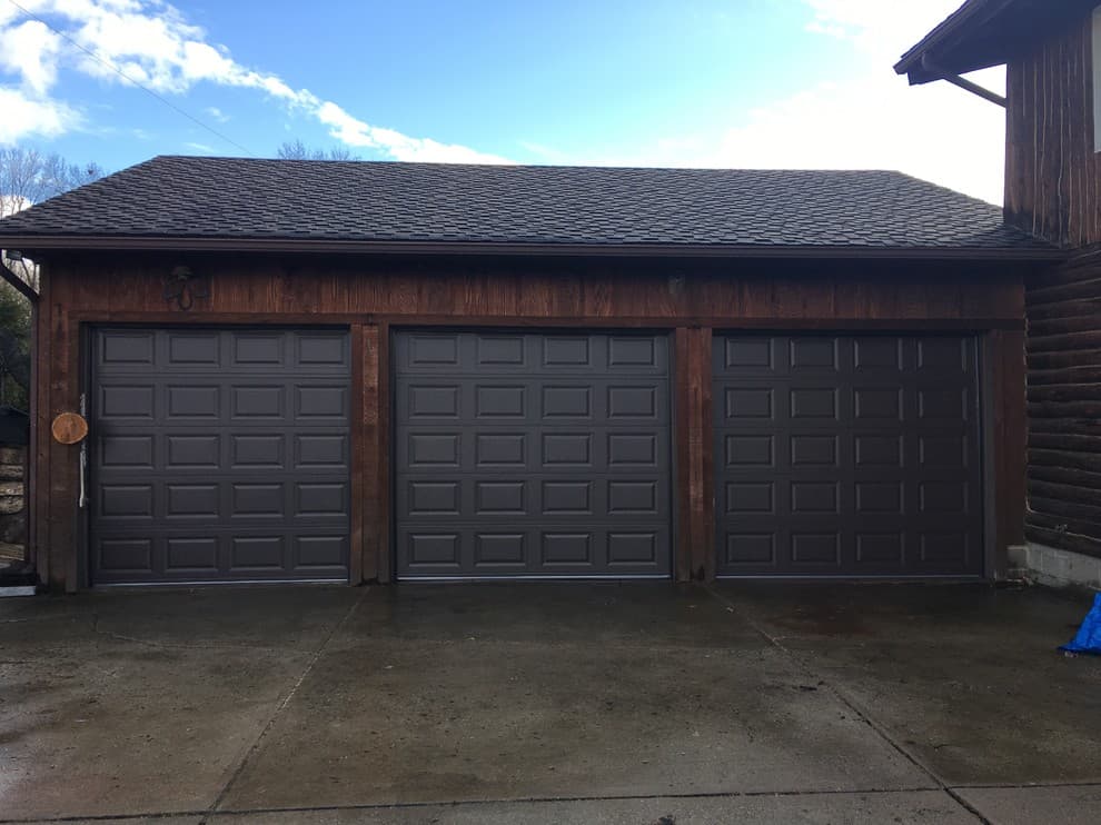 black garage door with brown house