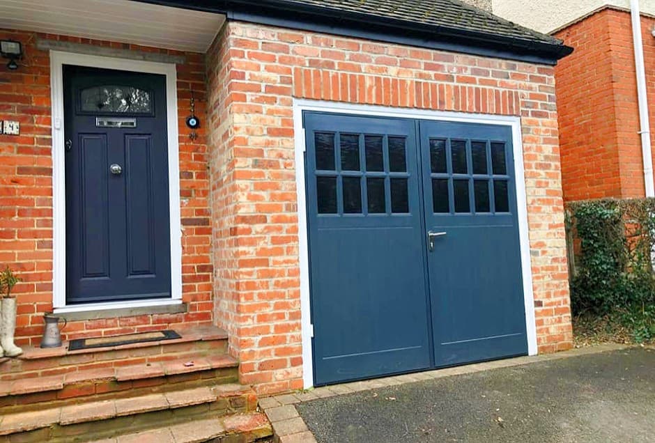 blue garage door with red brick house