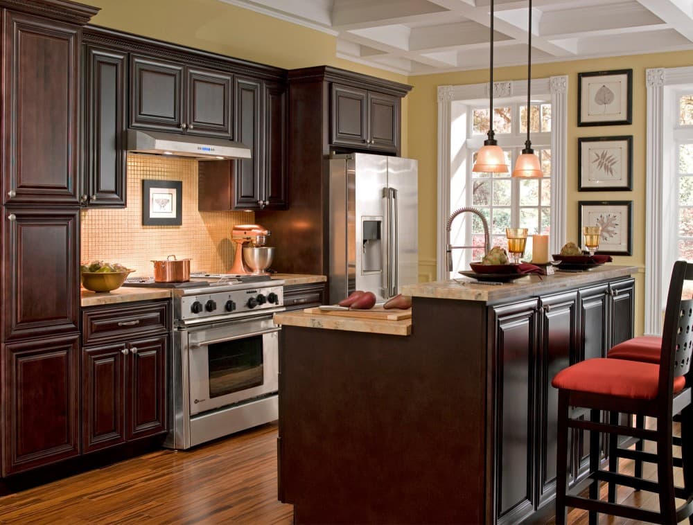 chocolate wood cabinets with brown granite countertops