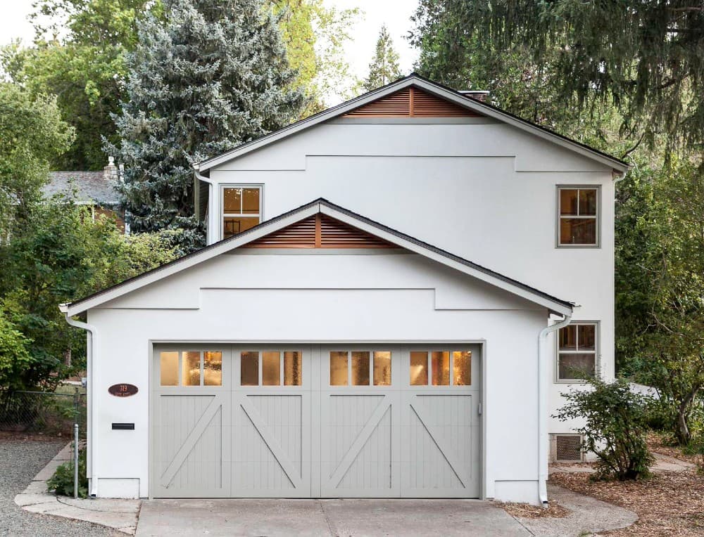 gray garage door color with white house