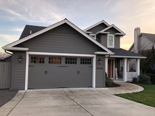 gray garage door with gray house