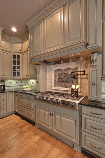 greige cabinets with brown granite countertops
