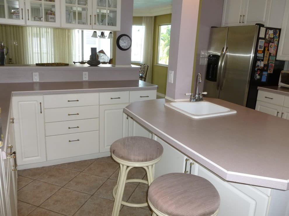 mauve countertop with white cabinets
