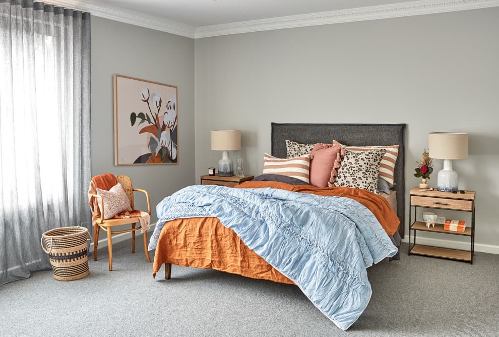 orange bedding with gray wall