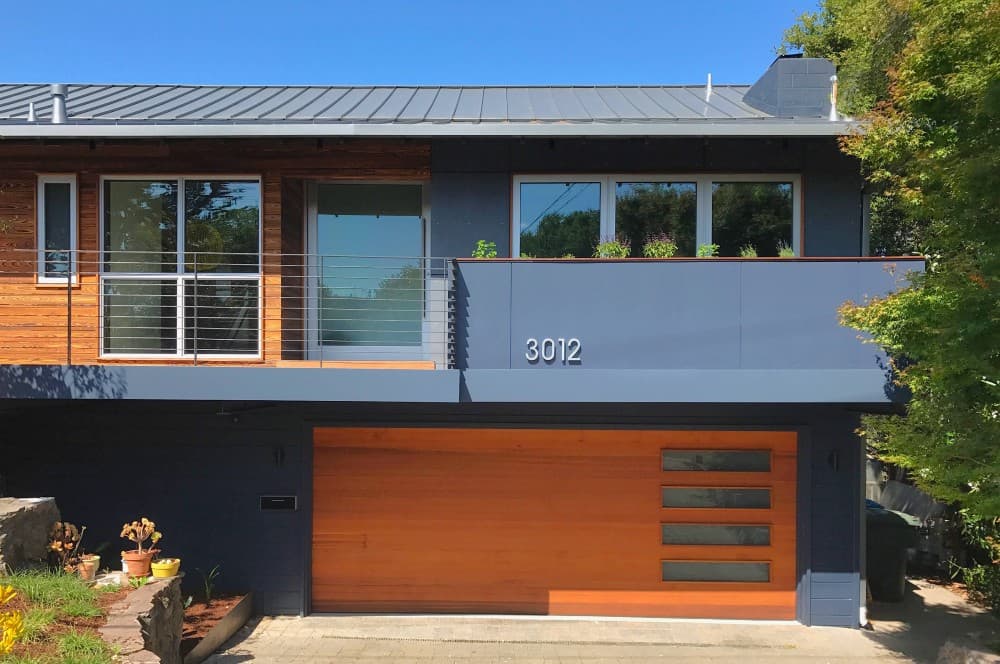 orange garage door with blue house