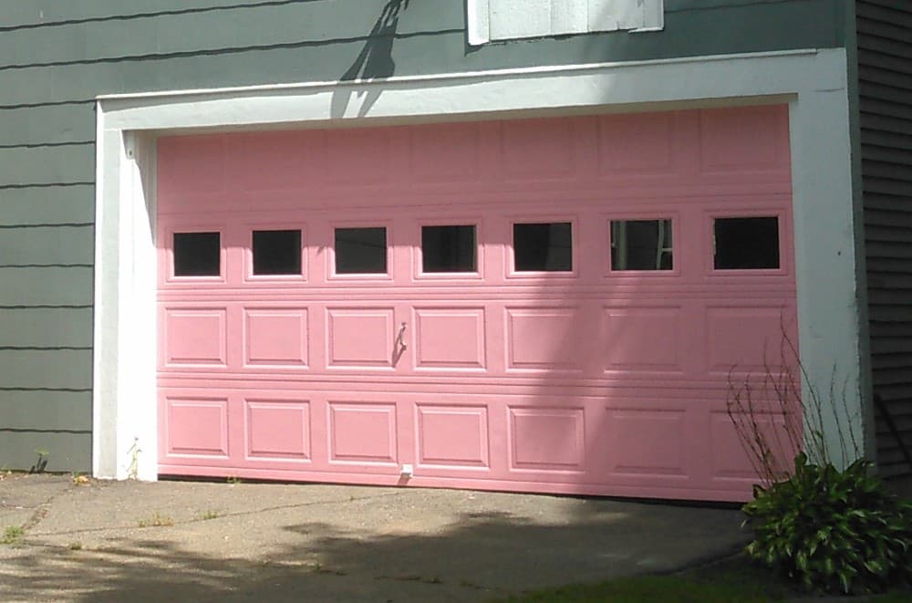 pink garage door with gray house