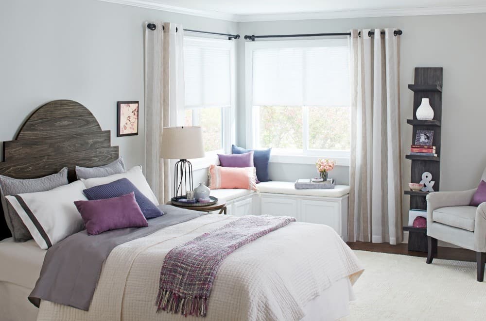 purple bedding with gray wall