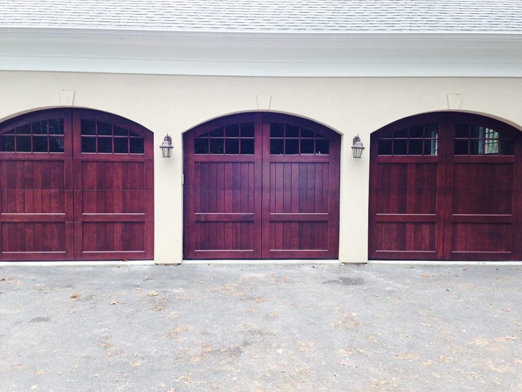 purple garage door with beige house