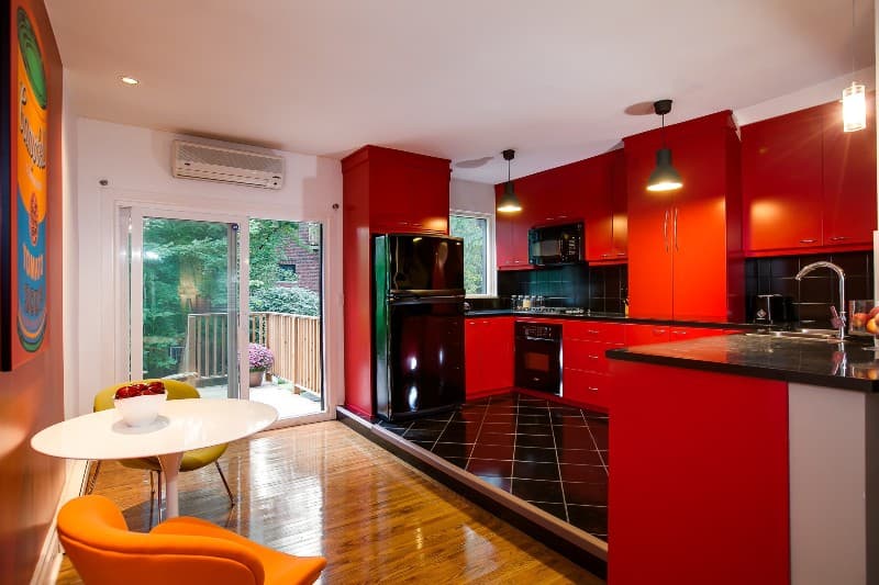 red cabinets with black stainless steel appliances
