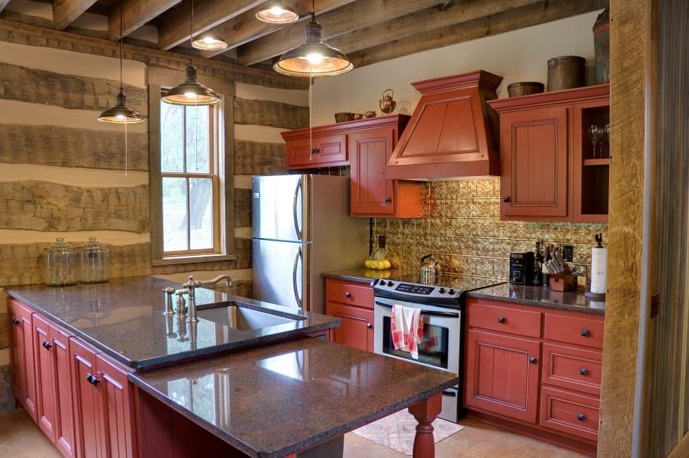red cabinets with brown granite countertops
