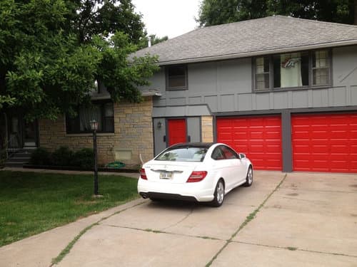 red garage door with gray house